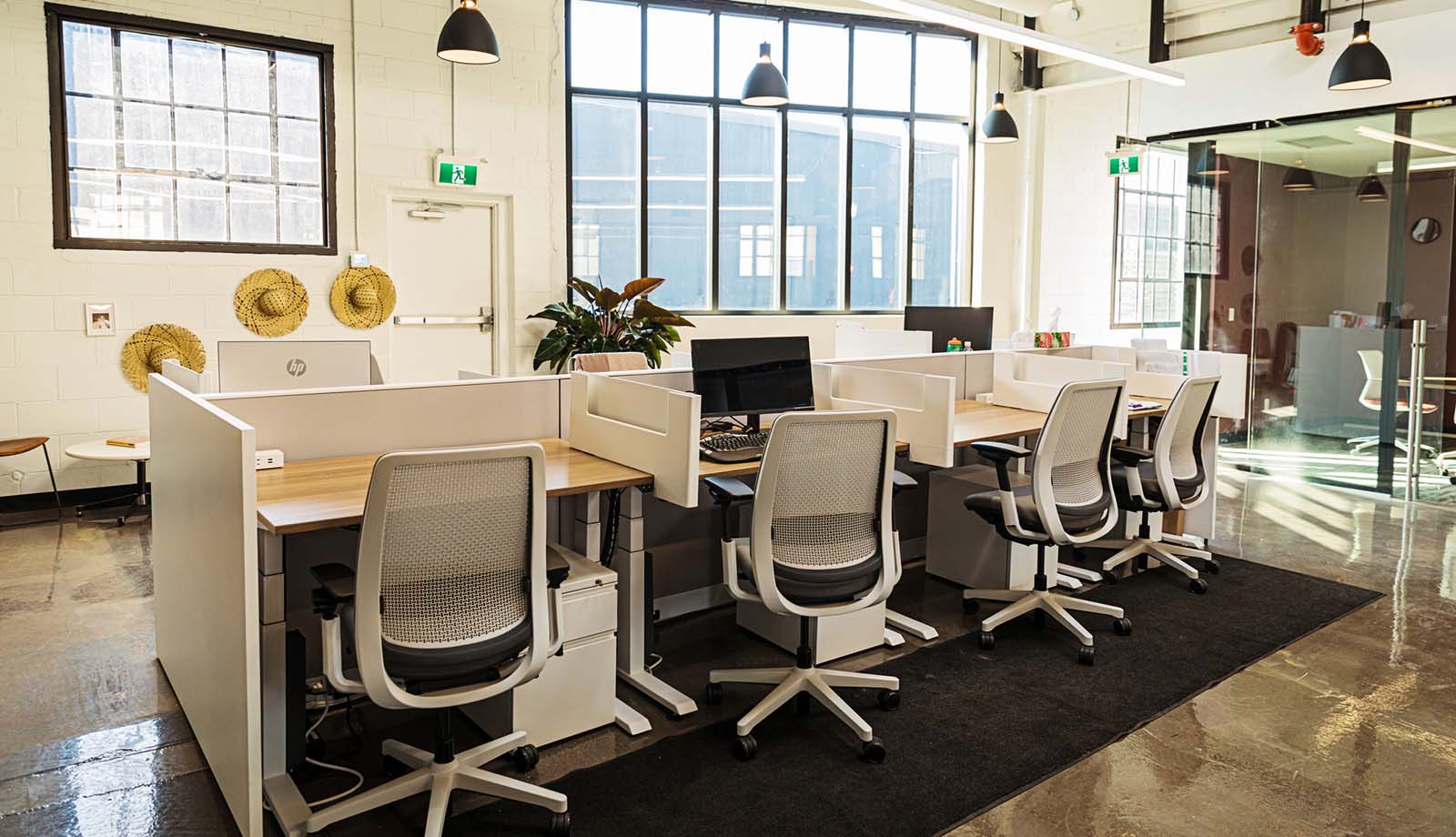 Modern coworking office interior with individual cubicles and big windows